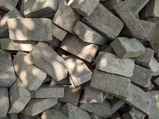 Pile of irregular paving blocks to cover the soil surface. With top angle