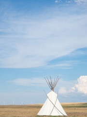 White Teepee in the Foreground with Wind Turbines in the Distance in Montana