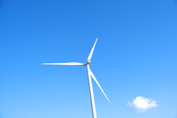 Wind farm on the mountain. Lonely windmill on a beautiful sunny day. Wind energy concept, alternative energy, renewable energy