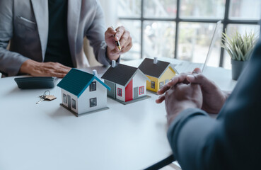 Buyers choose a home model design from real estate agent to buy new house construction and...