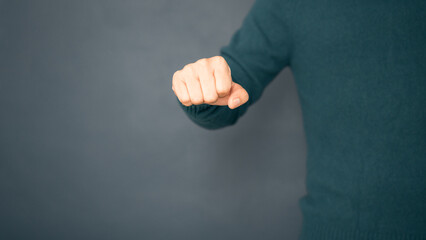 Adult man clenched his fists and showed an angry expression, ready to fight his target.