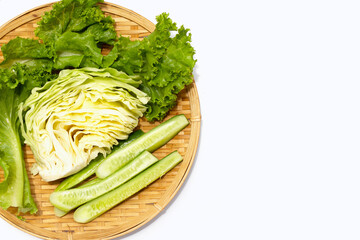 Green coral lettuce, cabbage and cucumber in bamboo weave plate