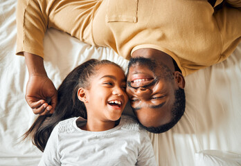 Black family, father and daughter love on a bed with a smile on face or laughing at funny memory....
