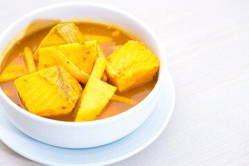 Curry with bamboo shoots and fish pieces.
