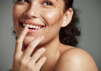 Woman, sugar scrub and lips with smile for skincare, makeup or cosmetics against a grey studio...
