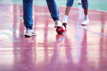 Selective focus to red ball with futsal player.