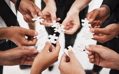 Hands, puzzle and business people collaboration, teamwork and integration closeup for planning. Team, hand and synergy with problem solving, partnership and people connecting to support innovation