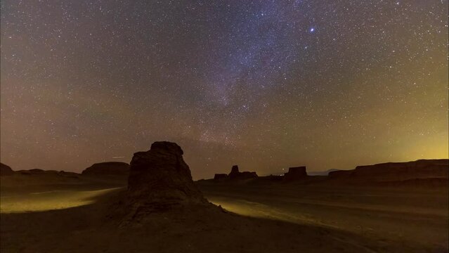 Bright Meteor at the Night sky full of stars and milky way galaxy shines in a starry dark landscape
Lut desert at night in Iran central climate landscape of landmark and landform of sand blast rocks