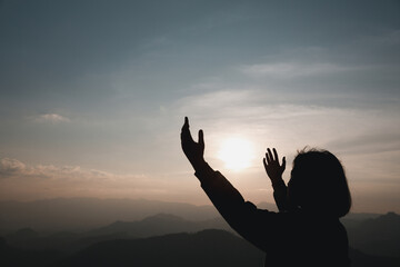 Faith christianity of christian worship concept. Spiritual prayer hands over sun shine with blurred...