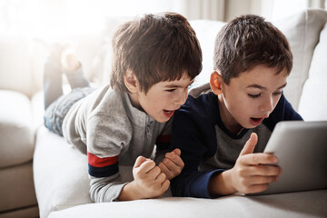Children, movies and tablet streaming for playing esports game, gaming bonding or social media in...