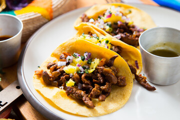Pork tacos. A taco is a traditional Mexican food consisting of a small hand-sized corn tortilla