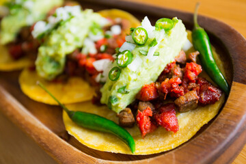 Tostada with beef and chorizo. Tostada, name given to various dishes in Mexico that include a toasted tortilla as the main base of its preparation.
