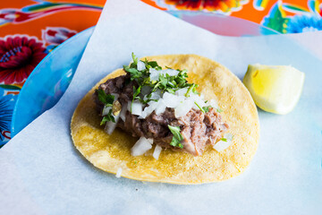 Pork tacos. A taco is a traditional Mexican food consisting of a small hand-sized corn tortilla