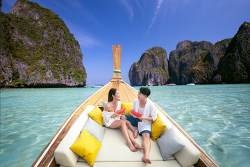 Asian couple lover travel and relax in they honeymoon trip on the wooded boat - 562637149