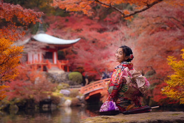 Asian traveler girl in Kimono traditional dress walking in old temple in Autumn season