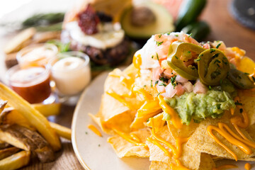 Nachos with guacamole. Nachos are a dish of Mexican origin, which consists of frying pieces of corn tortilla covered with a special cheese.