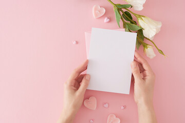 Valentines Day celebration concept. Top view photo of envelope with letter in hands, heart shaped...