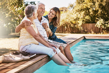 Relax, senior couple and woman with feet in swimming pool enjoying summer holiday, vacation and weekend. Family, love and daughter with elderly parents for bonding, quality time and laughing together