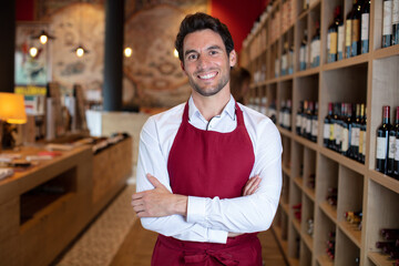 handsome sommelier in a wine shop or bar - obrazy, fototapety, plakaty