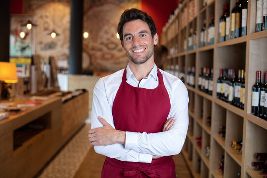 handsome sommelier in a wine shop or bar