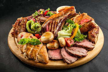 grilled potatoes and meat with various sauces and greens