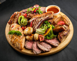grilled potatoes and meat with various sauces and greens