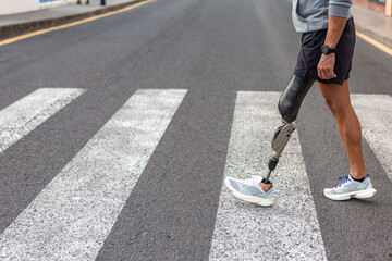 Handicapped male athlete crossing road