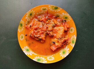 Fish Tenga - Assamese fish curry. Assamese fish Tenga is a delicious and sour Fish curry which is flavoured with various souring vegetables. This Tenga is prepared with tomatoes.
