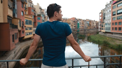A tourist looks at the sights in the city. Water channel and buildings