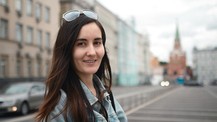 A young girl travels around Moscow. Kremlin in the background