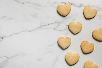 Freshly baked heart shaped shortbread cookies on marble background