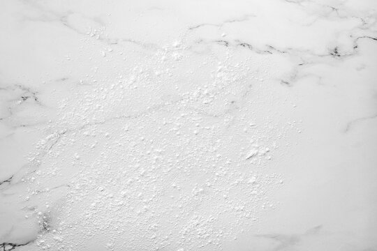 Marble background dusted with flour before rolling out cookie dough