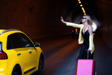 Woman with a suitcase take taxi. Yellow taxi. Dreams of travel. Traveler tourist woman in fashion...