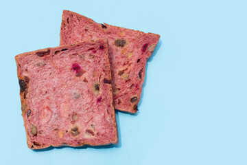 Whole grain bread slices on blue background.