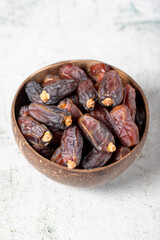 Fototapeta premium Date fruit on stone background. Organic Medjoul dates in a glass bowl. Ramadan food. close up