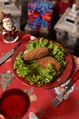 kiev cutlet shaped with tomato and lettuce leaves