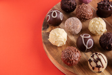 photo round chocolate candies on a wooden kitchen board