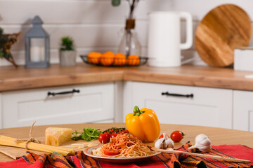 Freshly cooked pasta with tomato and parmesan cheese on the table