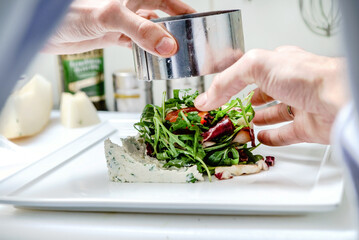 chef making salad in restaurant