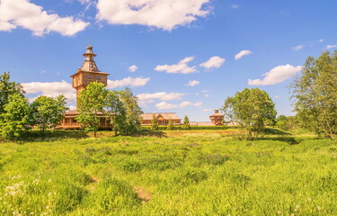 Summer landscape with a wooden Orthodox chapel on a meadow