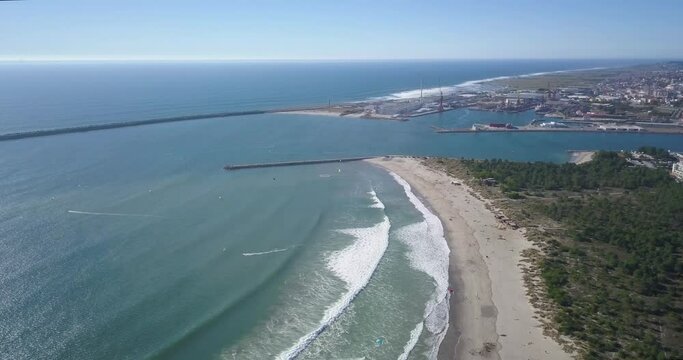 aerial view of some surfers kiting on a sunny day at Praia do Cabedelo, Viana do Castelo.