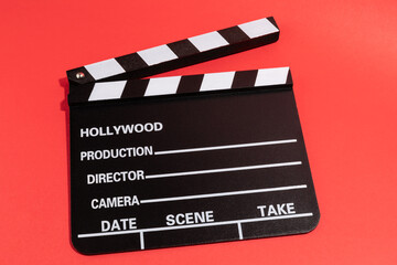 Obraz premium Clapperboard or clap board or movie slate, video production ,film, cinema industry on red background.