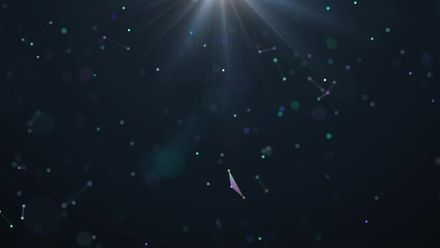 Multicoloured particles rotate through a thickness of substance shone through by thin beams.