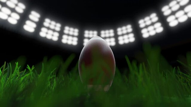 Rugby ball in football stadium with floodlights loopable super bowl concept