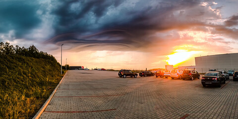 Storm clouds over the parking in the middle of the city during sunrise - 562667166