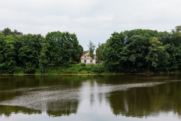 Fototapeta na wymiar Zabytkowy pałac w otoczeniu zielonego zabytkowego parku