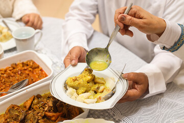 Hand holding a plate of special indonesian food. Traditional menu during Eid mubarak in Indonesia.