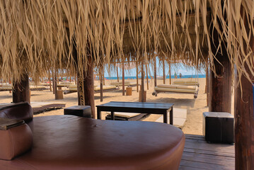 Sun loungers with sofas on a clean sandy beach. sea view with horizon, tranquility and relaxation. Inspirational beach resort