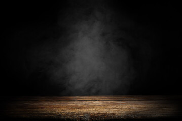 Dark empty wooden table with smoke float up on dark wall background. Free space for your decoration.  - 562670731