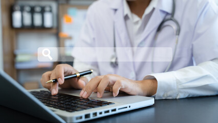Male doctor working on desk with laptop computer and paperwork in the office. Medical and doctor concept.